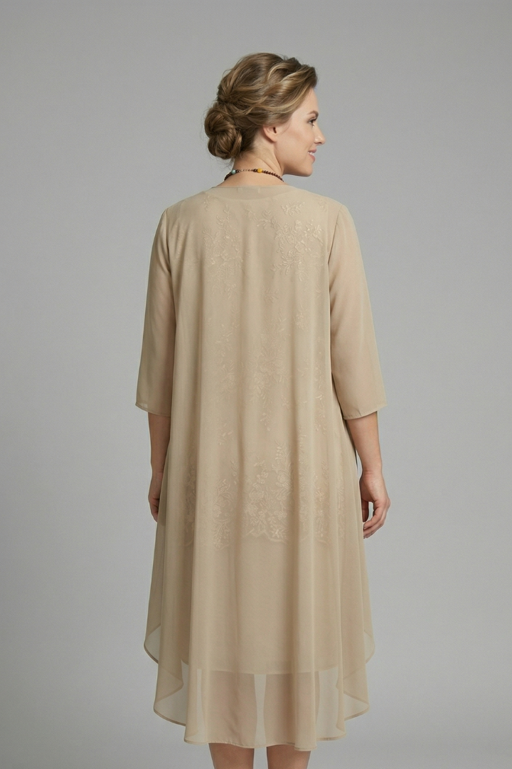 Sophisticated women's cocktail dress: layered design, sheer overlay, round neck, & short sleeves. Chic knee-length style.