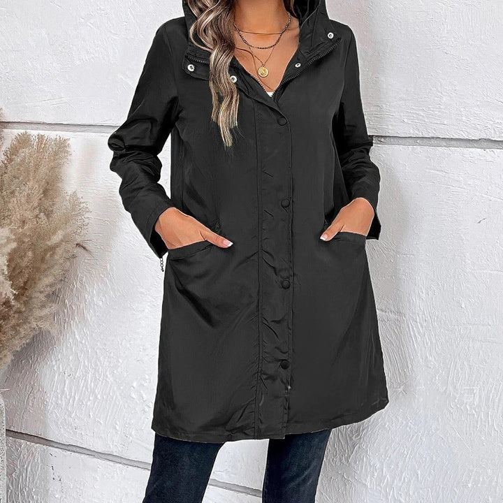 Elegant women's long autumn coat with a stylish high collar and button tab closure, perfect for fall fashion.