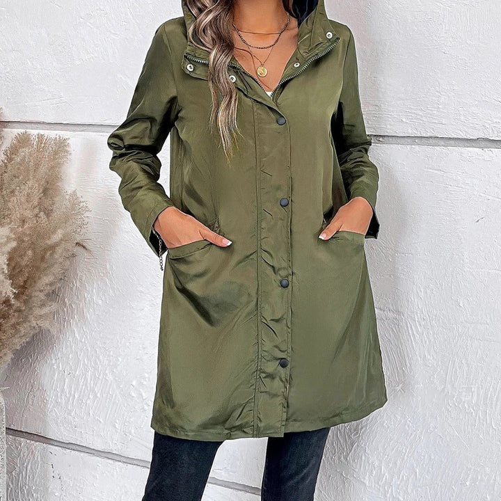 Stylish women's long autumn coat providing warmth and comfort, featuring a high collar and versatile button details.