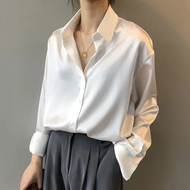 Versatile women's satin blouse with long sleeves and button-down front, ideal for office and evening wear.