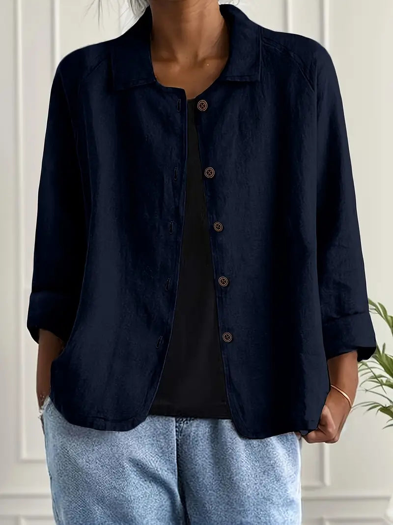 Close-up of open collar and buttons on an elegant women's long sleeve button-up blouse. A refined, stylish detail.