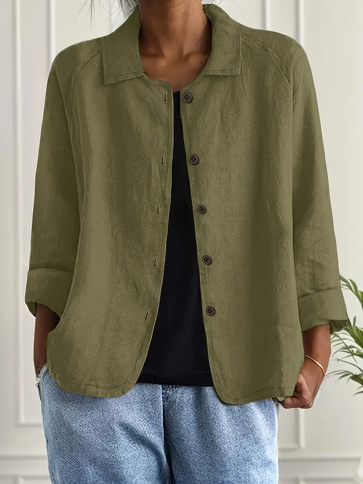 Model wearing elegant women's long sleeve button-up blouse. Sophisticated relaxed fit top, ideal for various settings.