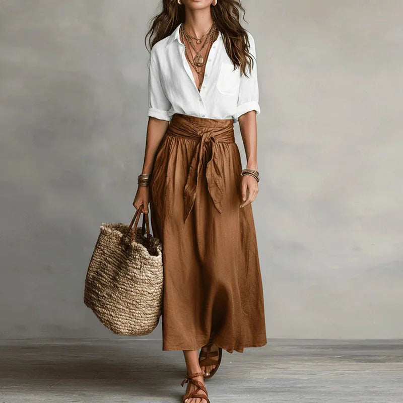 Versatile women's two-piece skirt suit with a long-sleeve top and matching skirt for a polished, modern look.