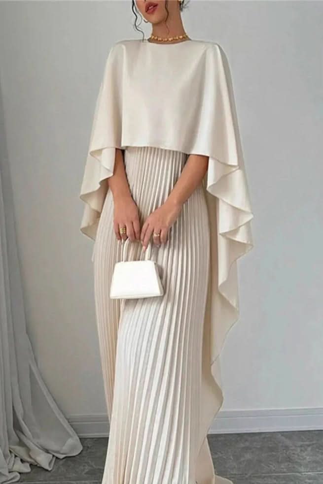 Woman in a flowing Luxe pleated cape maxi dress, an elegant long formal gown for a party or special occasion.