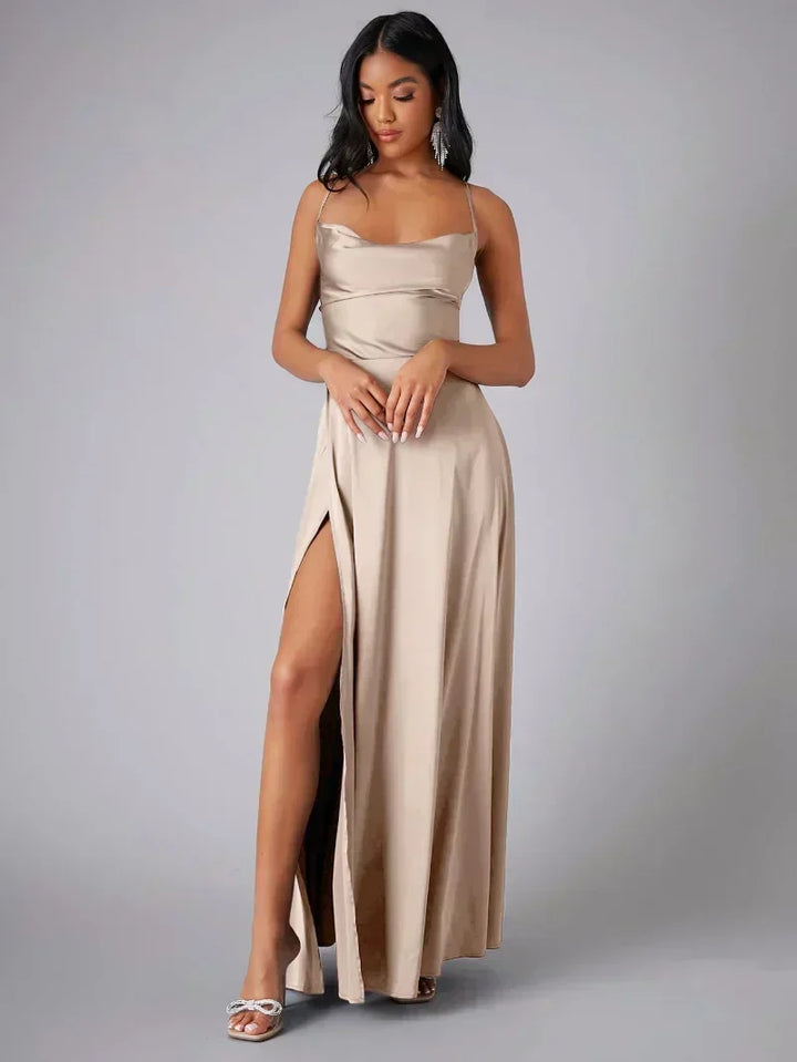 Elegant women's maxi evening dress with high slit, open back, & draped neckline. Perfect for formal occasions.