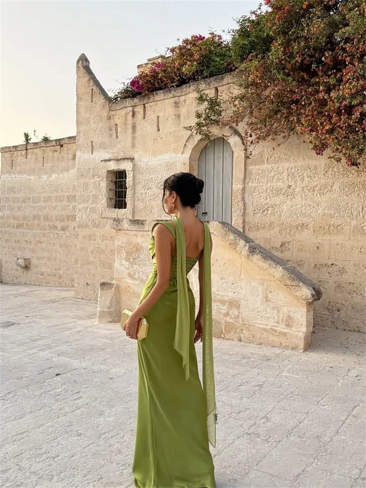 Luxurious women's open-back maxi dress. Elegant formal wear for wedding guests & evening events. Sleeveless design.