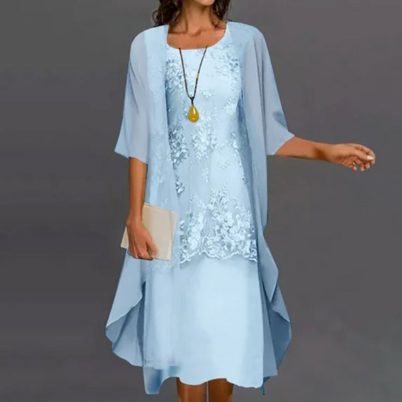 Elegant women's midi dress and matching cardigan set. Perfect for summer occasion wear or a formal party.
