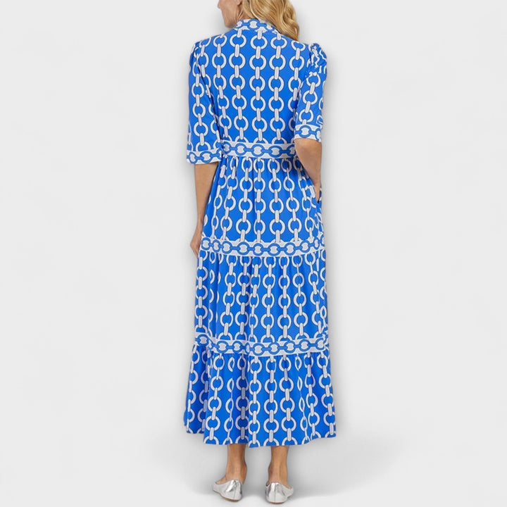 Orange women's midi dress with a bold chain pattern, combining elegant fashion and all-day comfort.