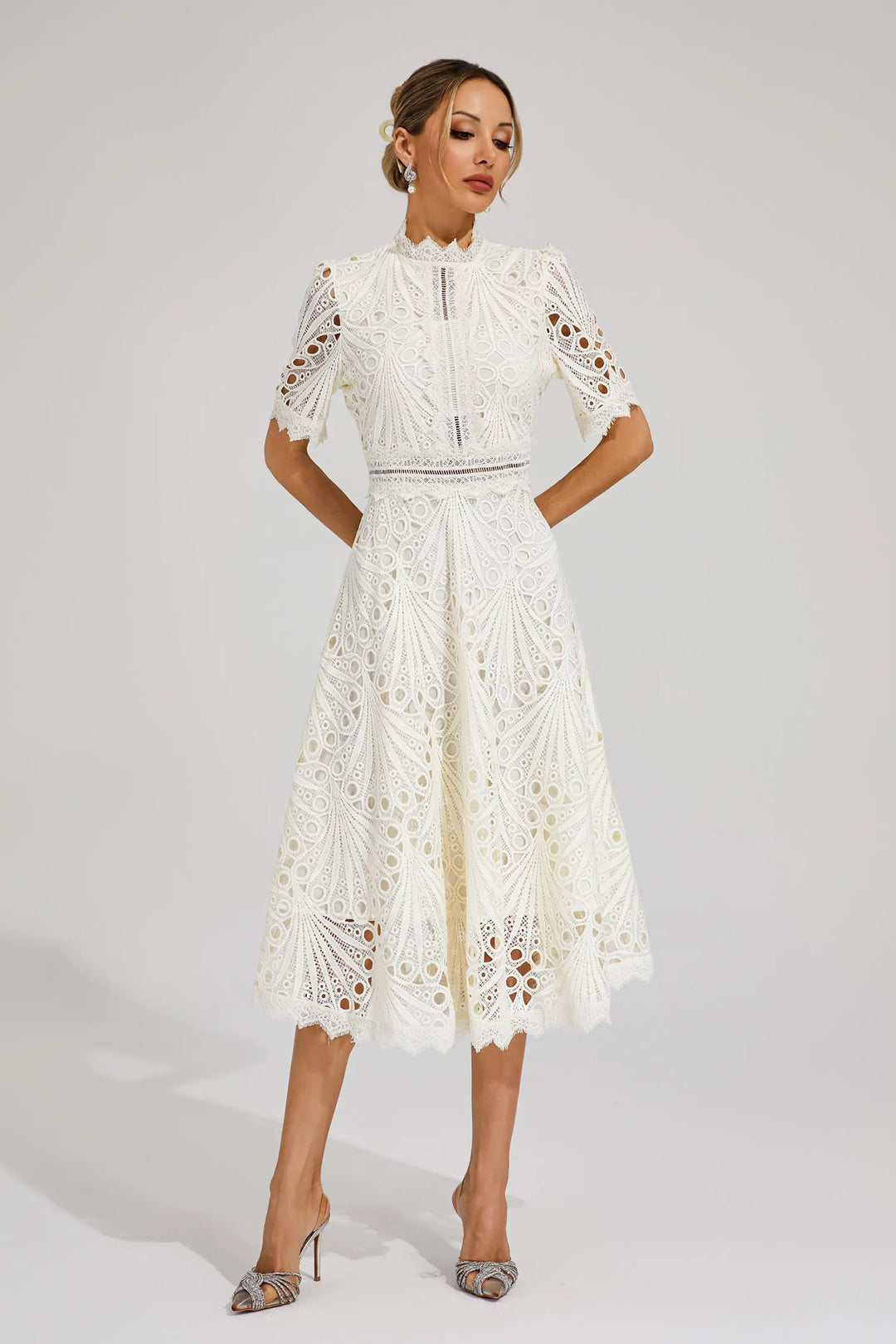 Close-up of the delicate fabric and texture of a women's pink lace midi dress.