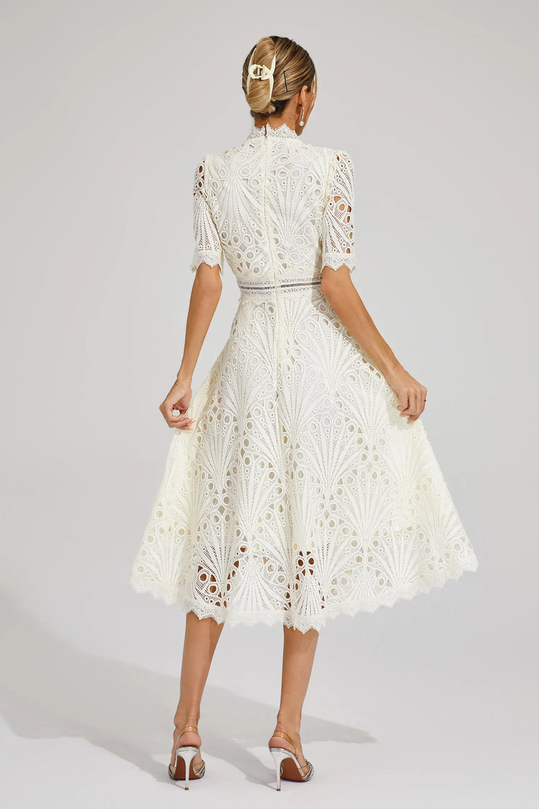 Elegant women's white lace midi dress, suitable for weddings and other formal gatherings.