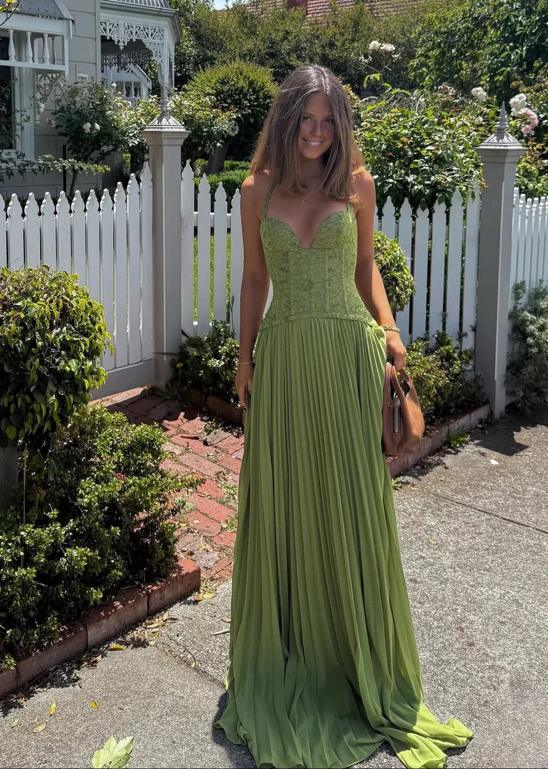 Stunning green halter neck maxi dress with pleated skirt & corset style bodice. Ideal for wedding guests.