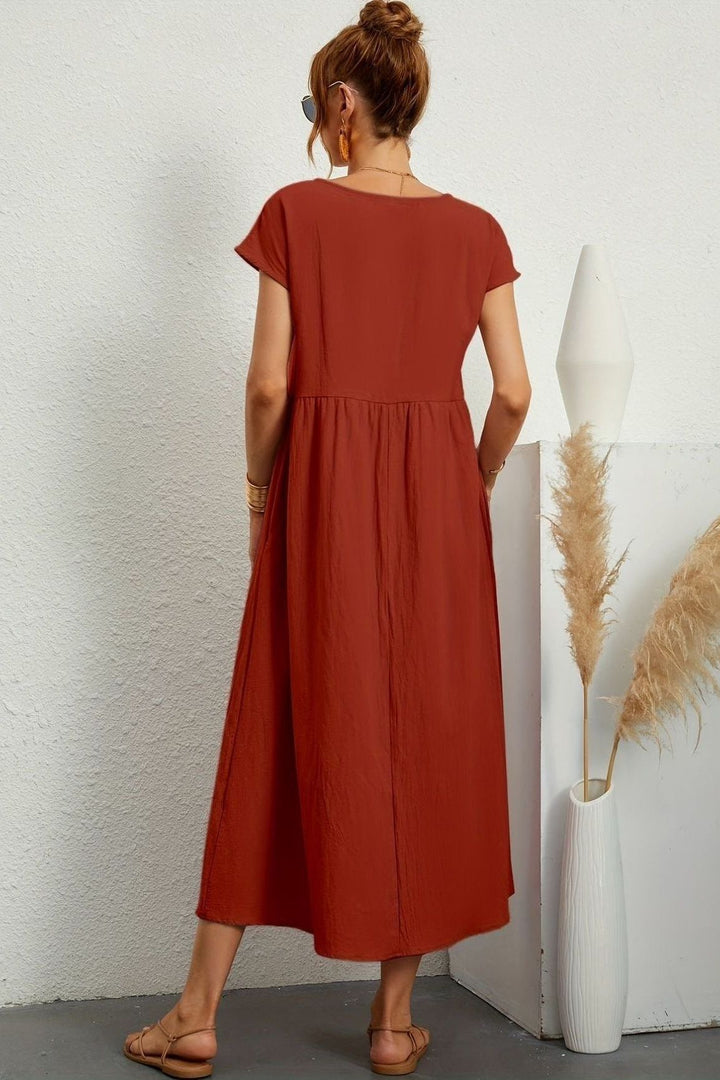 Sophisticated women's pleated midi dress, offering effortless elegance for any event.