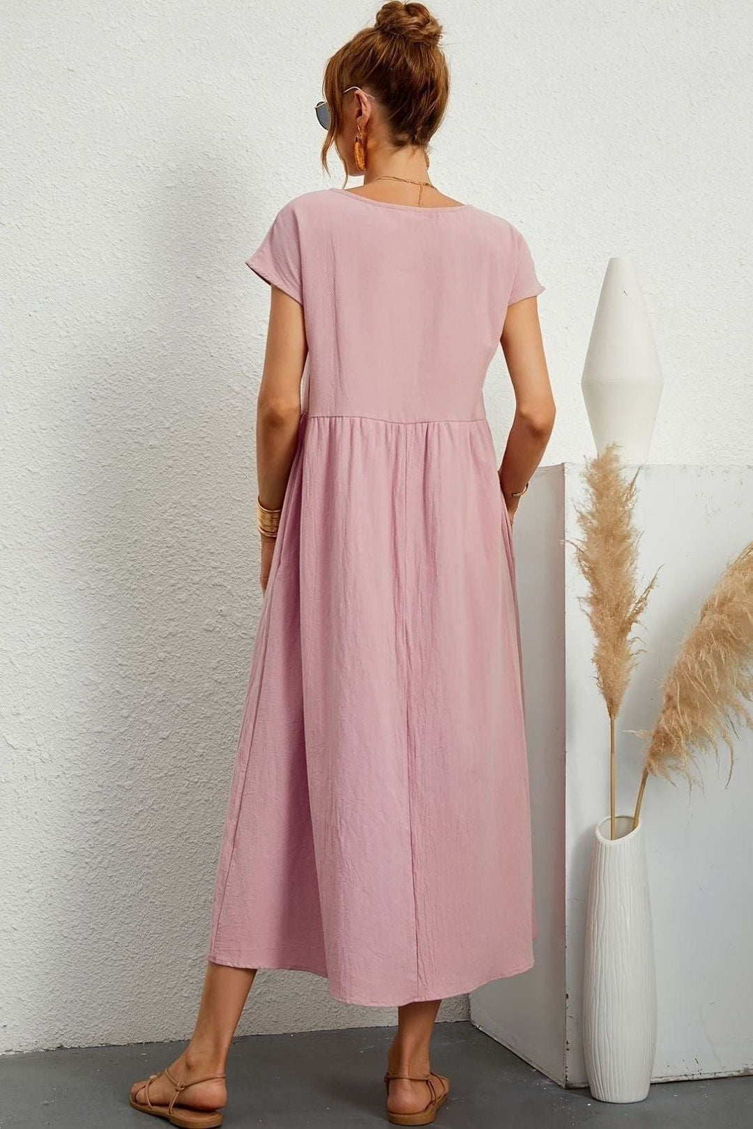 Women's elegant midi dress. Pleated for effortless style, suitable for various occasions.