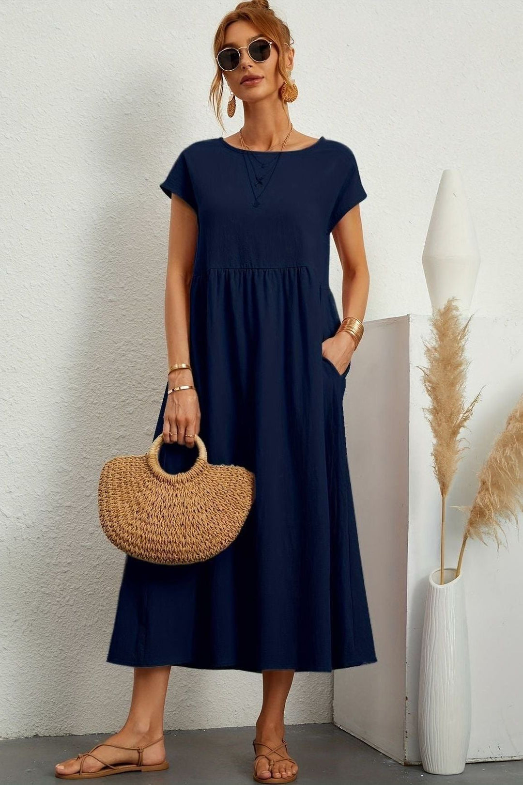 Versatile women's midi dress with elegant pleats, ideal for spring and summer parties.