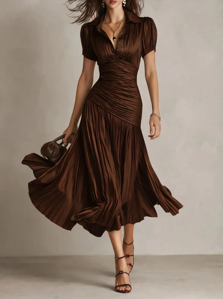 Chic flowing women's pleated A-line midi dress, elegant design for sophisticated occasion wear.