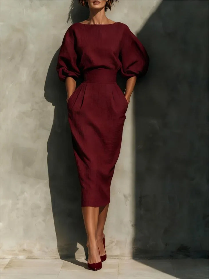 Sophisticated pleated midi dress for women, featuring chic lantern sleeves & a flattering cinched waist. Ideal for office or formal events.