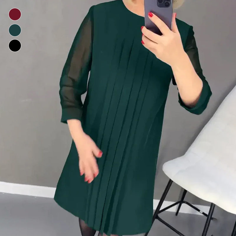 Full-length view of a polyester women's pleated round neck midi dress, fashionably styled