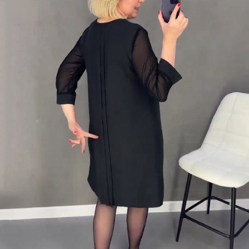 Detail of the mid-sleeve on a women's elegant pleated midi dress, suitable for all seasons