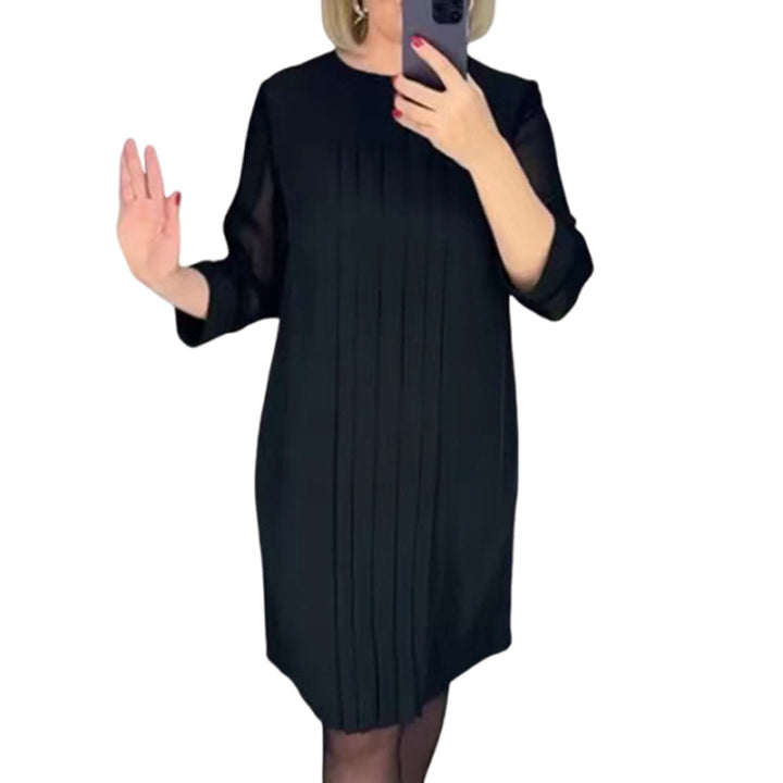 Fashion shot of a women's pleated round neck midi dress, emphasizing its comfortable wear