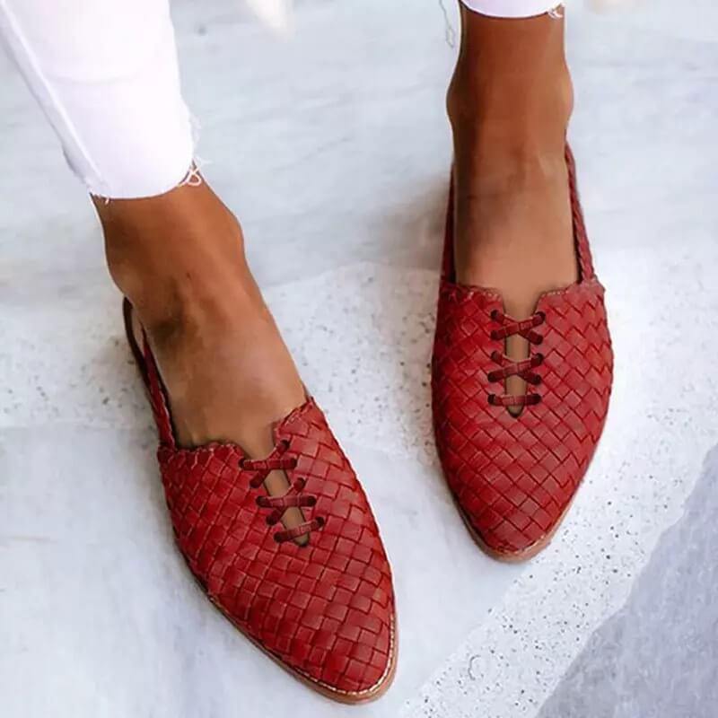 Side view of comfortable women's pointed toe flat loafers. Features chic lace-up detail and elegant slip-on style.
