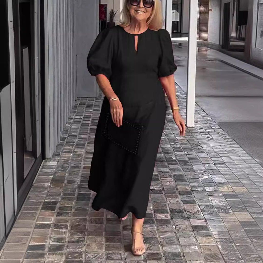 Stylish women's long sleeve A-line midi dress featuring puff sleeves and a keyhole neckline.