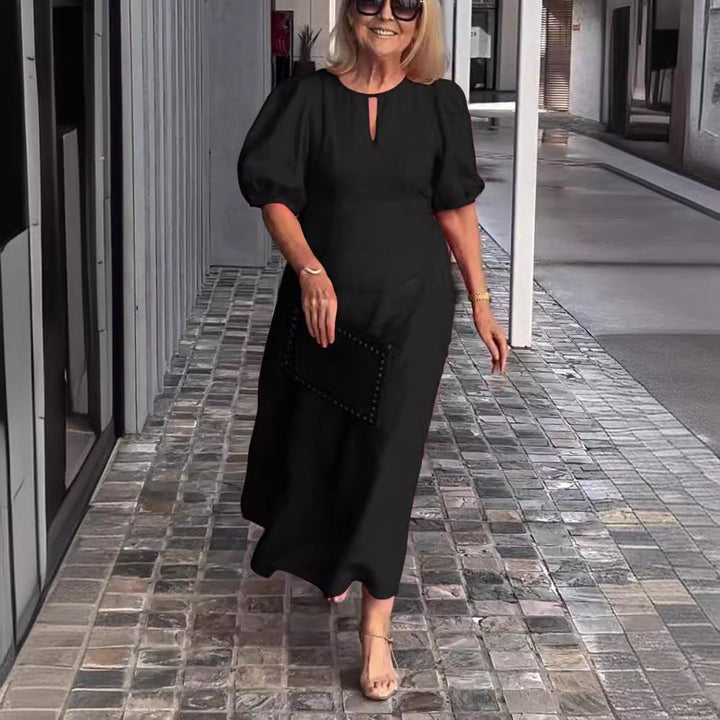 Stylish women's long sleeve A-line midi dress featuring puff sleeves and a keyhole neckline.