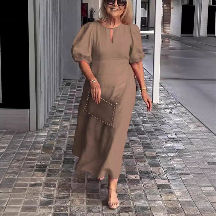 A women's puff sleeve A-line midi dress shown in full length, perfect for an elegant party.