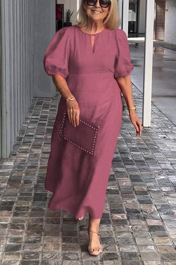 Comfortable women's midi dress with elegant puff sleeves, a versatile piece for stylish casual wear.