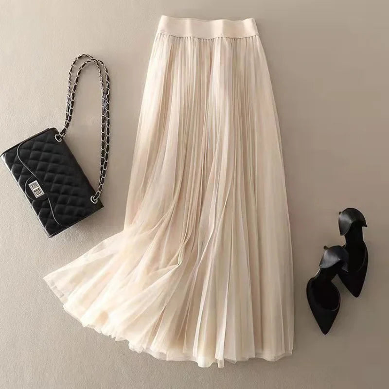 Vibrant red pleated midi skirt for women. Flowy A-line, high-waist design, perfect elegant casual summer fashion.