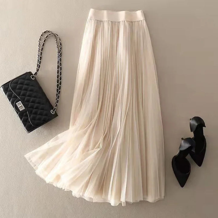 Vibrant red pleated midi skirt for women. Flowy A-line, high-waist design, perfect elegant casual summer fashion.