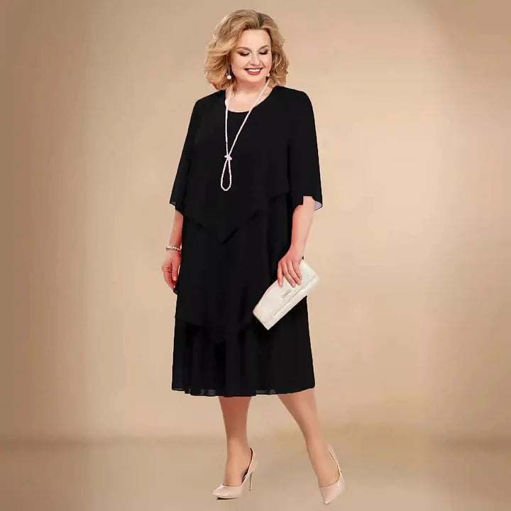 Classic black A-line midi dress for women. Flattering fit, 3/4 sleeves, round neck. Elegant for any party or event.