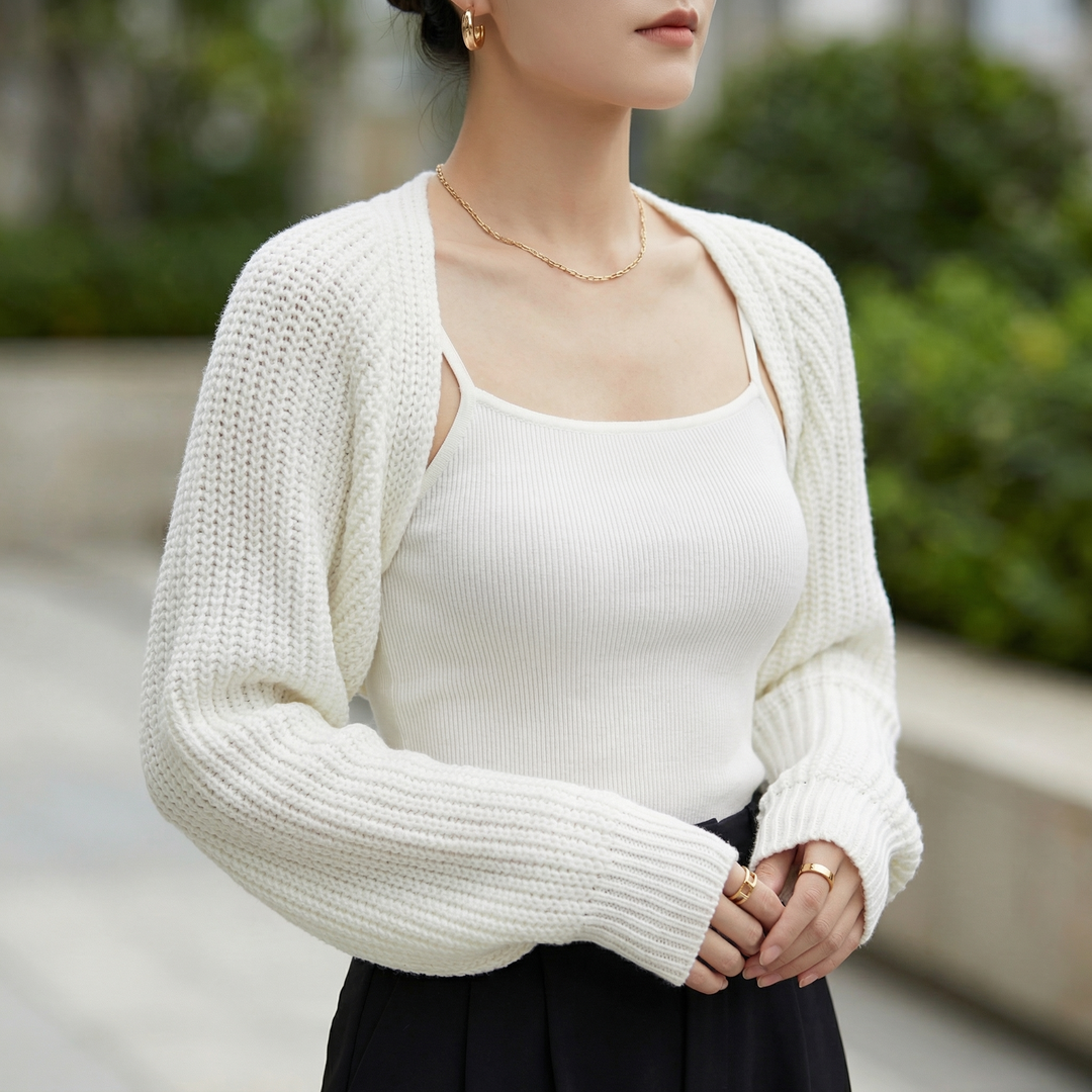 Elegant women's ribbed shrug cardigan for stylish layering. Long sleeve cropped design, perfect versatile outerwear.