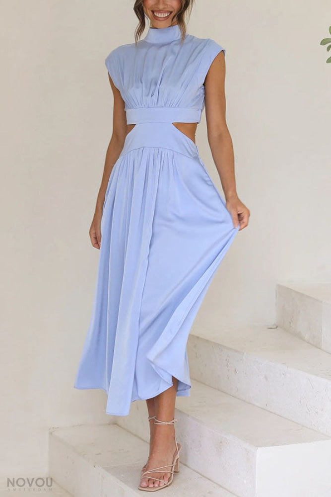 Side profile of elegant summer midi dress featuring a roll neck & unique waist cut-out.