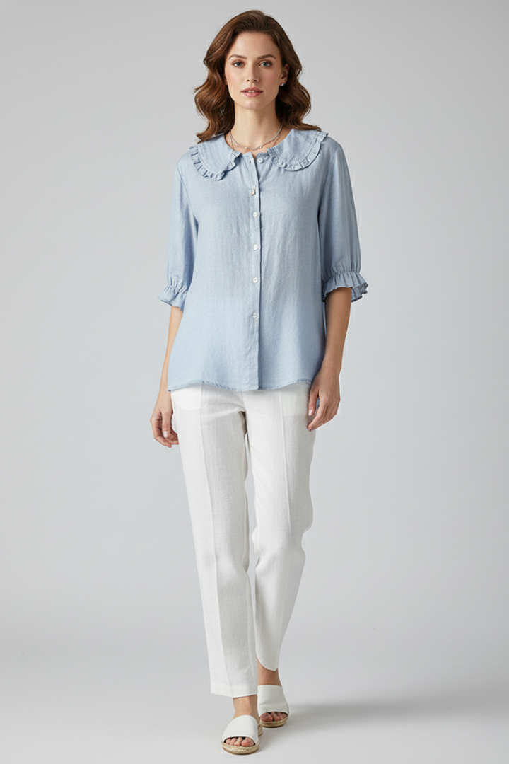 Close-up of the delicate ruffled collar on a women's button-up shirt, an elegant top with mid-length sleeves.