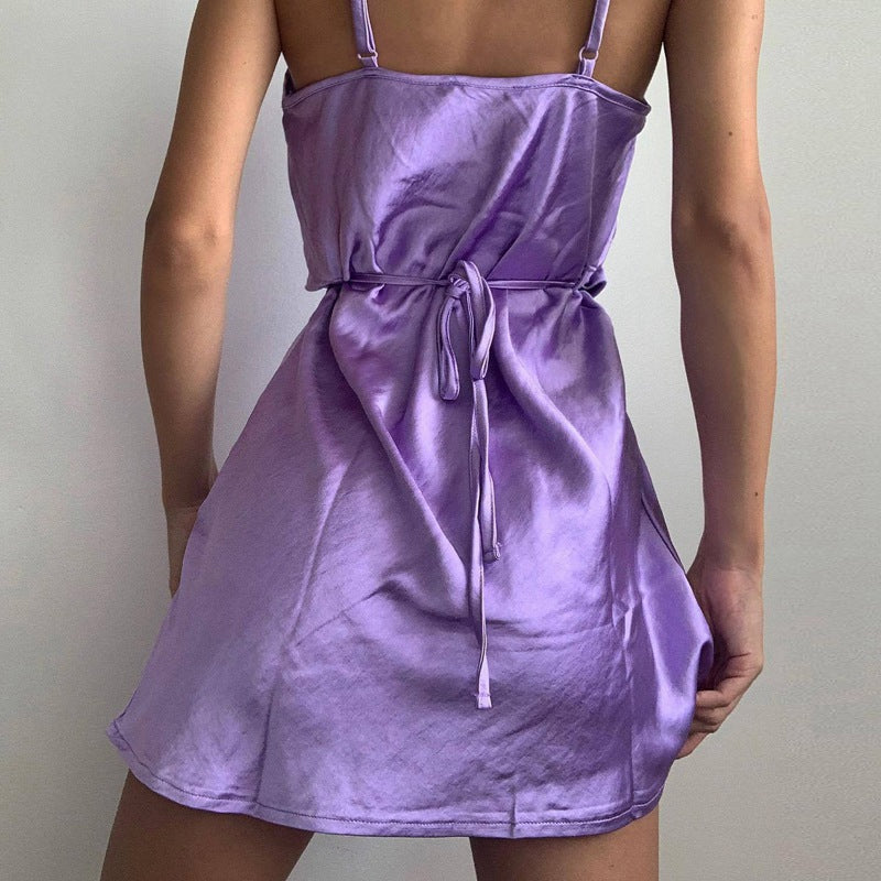 Full length image of a woman in a glamorous gold satin mini slip dress, party ready