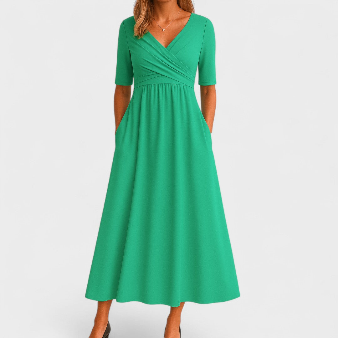 Woman wearing a versatile elegant A-line wrap dress with 3/4 sleeves, styled for a semi-formal work look.