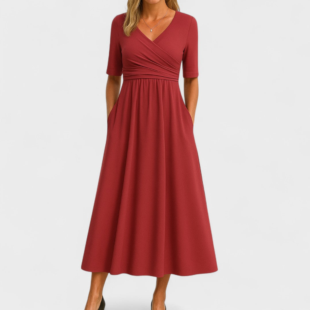 Detail of 3/4 sleeves and flattering wrap waist on an elegant women's A-line semi-formal midi dress.