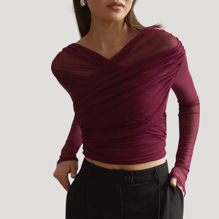 Close-up of a women's sheer wrap long-sleeve top, highlighting the lightweight fabric and elegant design.