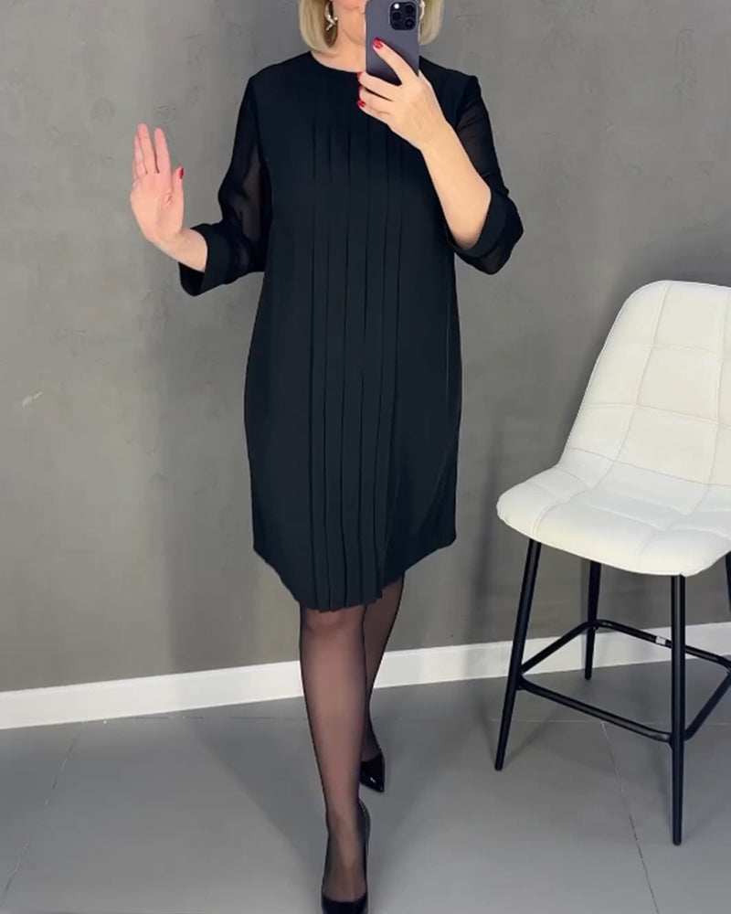 Elegant women's shift dress with stylish mesh details, long sleeves, and knee-length cut.