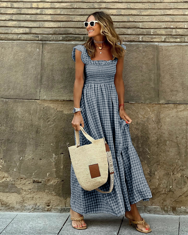 Flowy women's maxi dress with a sophisticated square neck, ruffle sleeves, and elegant tiered skirt design.
