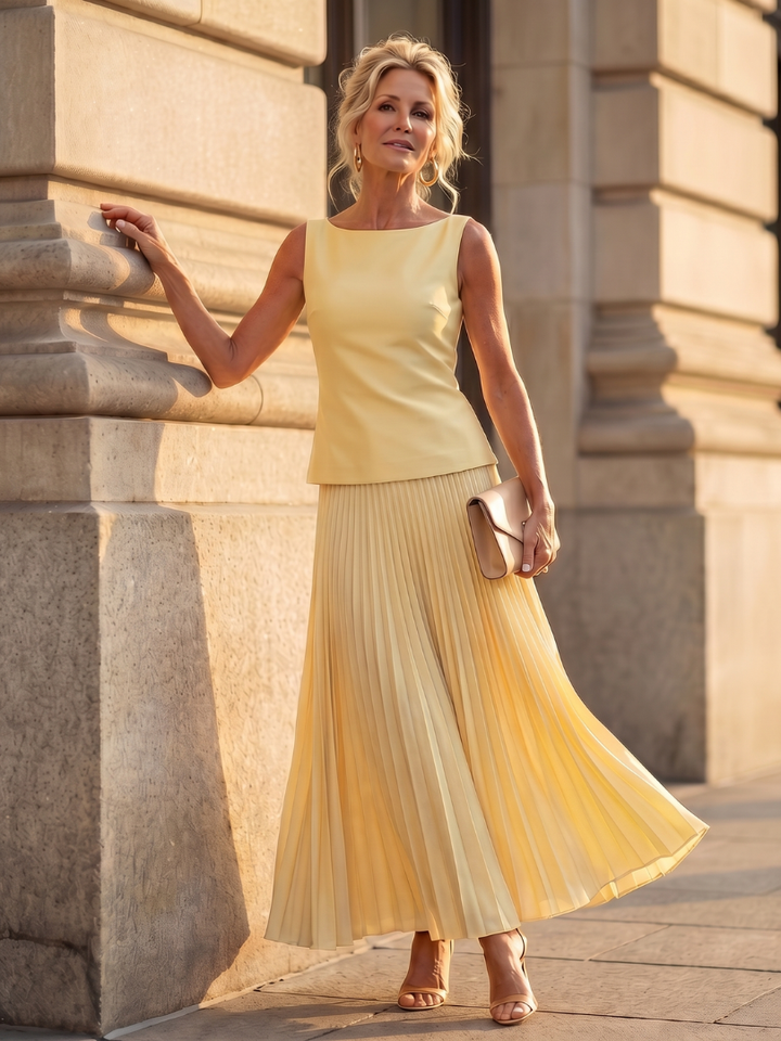 Elegant women's structured bodice sleeveless top & pleated maxi skirt set. Perfect for occasion wear.