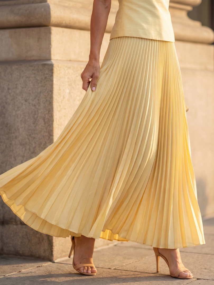 Coordinated women's skirt set featuring a fitted bodice and a graceful pleated maxi skirt.