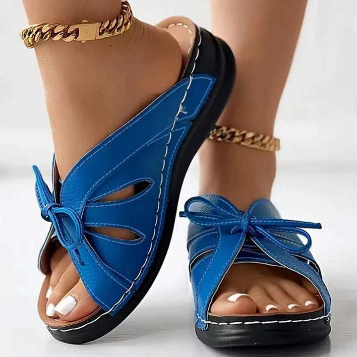 Elegant women's summer footwear: flat sandals with a charming bowknot accent