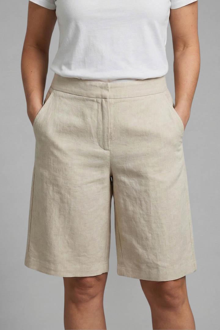 Comfortable women's tailored shorts, knee-length & flat front, ideal for versatile elegant fashion.