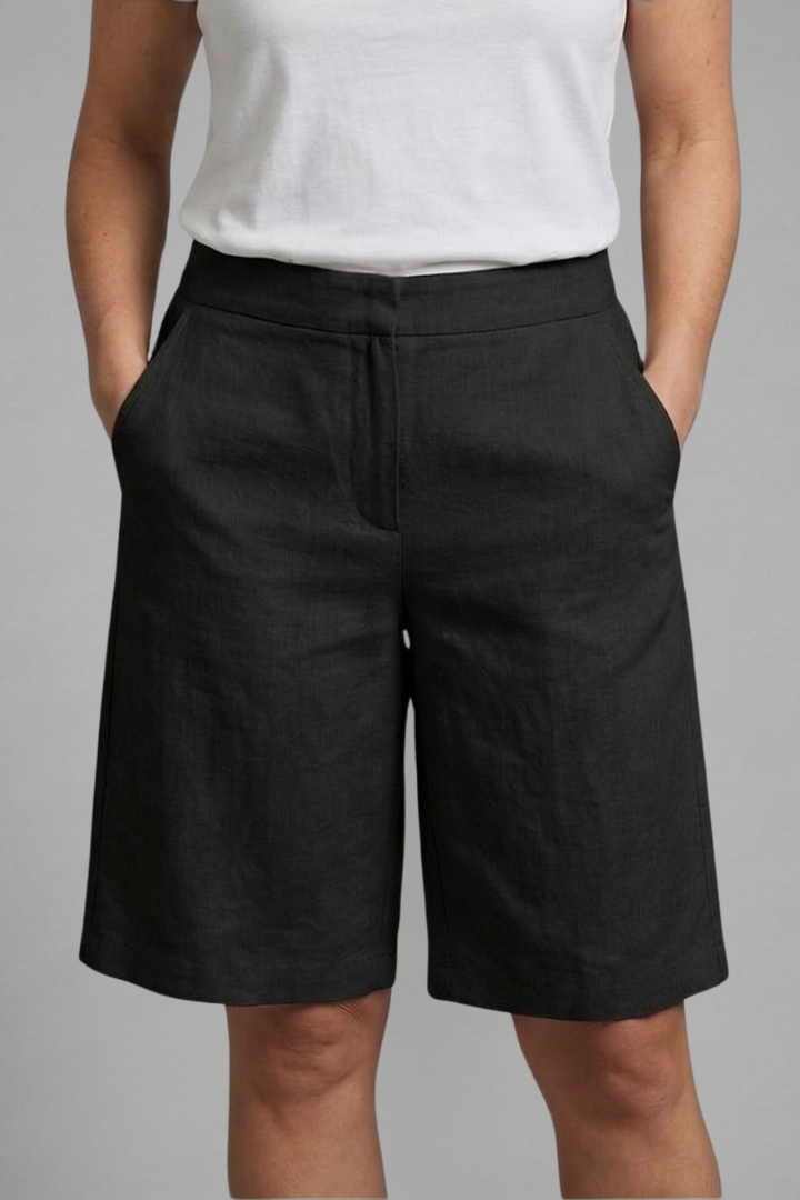 Elegant women's flat front shorts, tailored and knee-length, ideal for chic and versatile summer fashion.