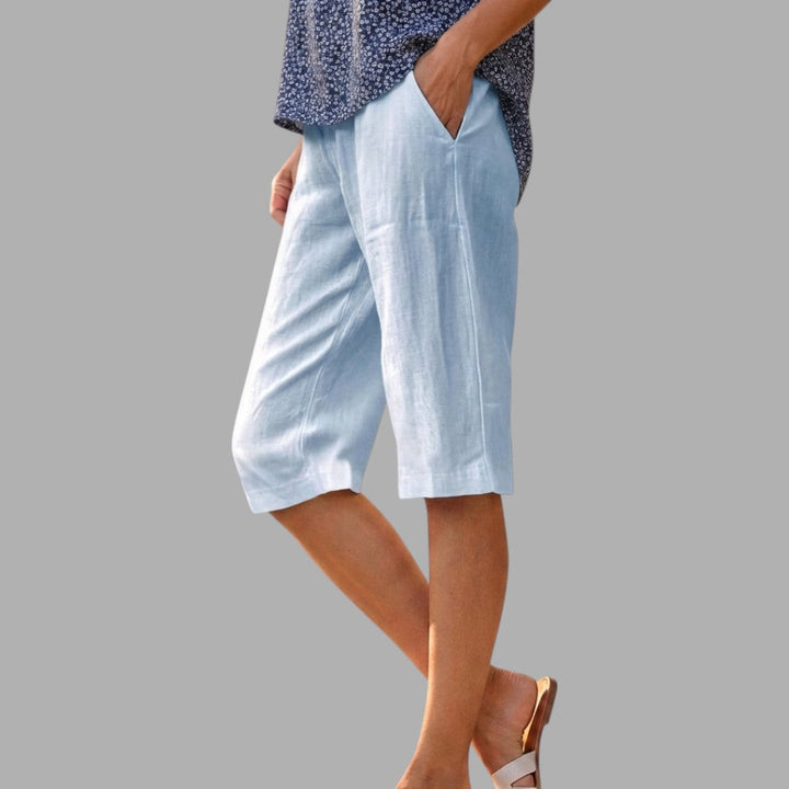 Sophisticated women's tailored knee-length shorts for an elegant summer look. Smart casual fashion.