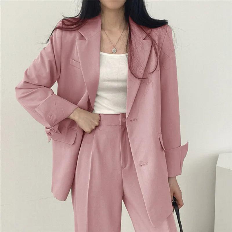 Elegant women's tailored suit set with long blazer and trousers, perfect for business wear