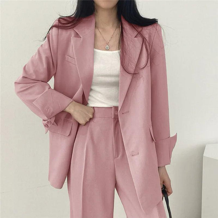Elegant women's tailored suit set with long blazer and trousers, perfect for business wear