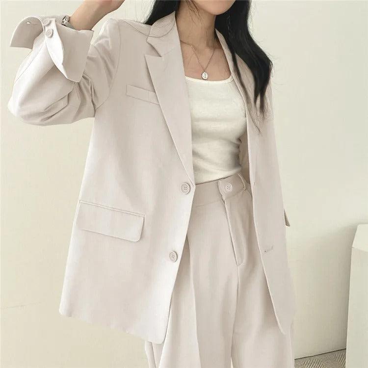 Contemporary women's elegant tailored suit with a statement long blazer and trousers