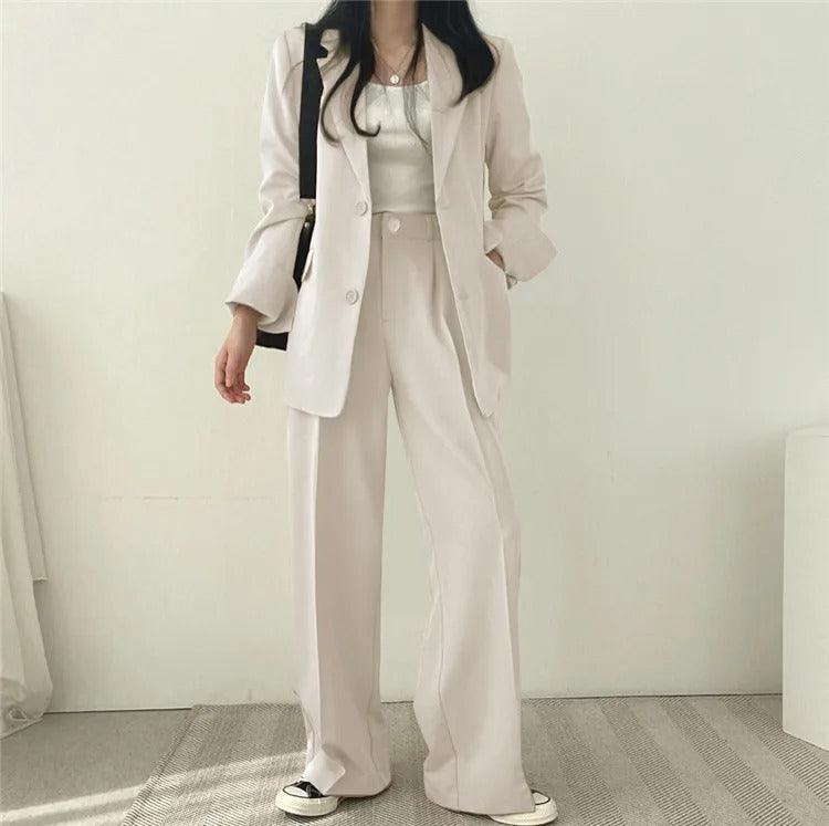 Dressy women's suit: long tailored blazer paired with refined matching trousers